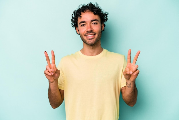 Showing victory sign and smiling broadly