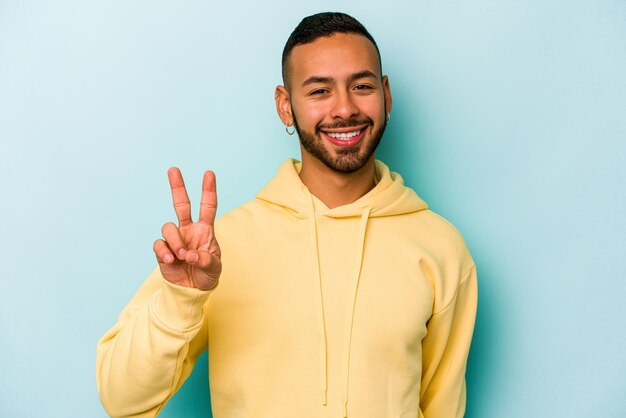 Showing victory sign and smiling broadly