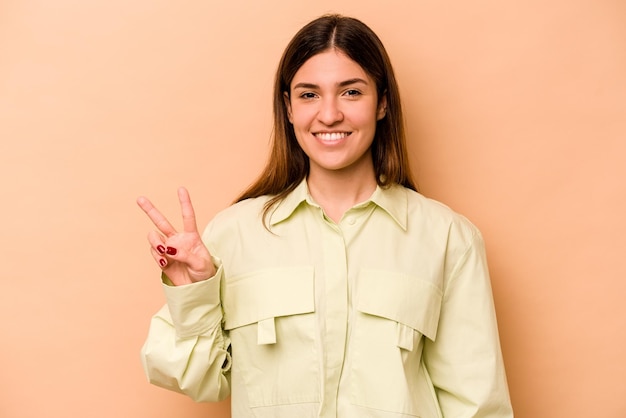 Showing victory sign and smiling broadly