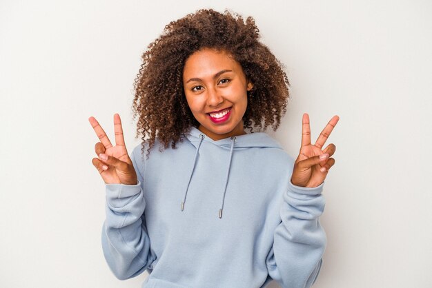 Showing victory sign and smiling broadly