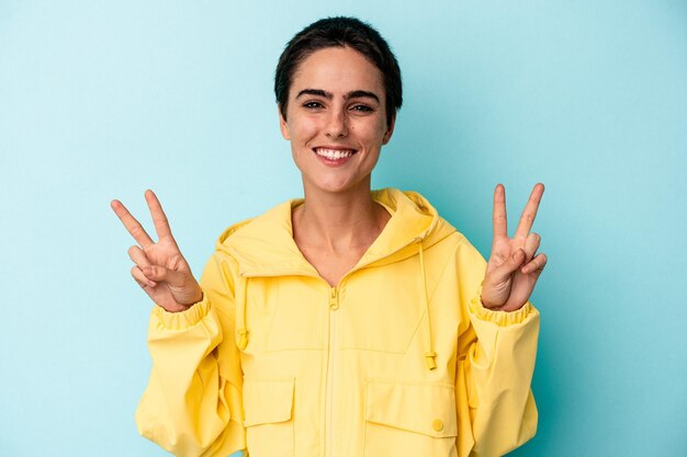 Showing victory sign and smiling broadly