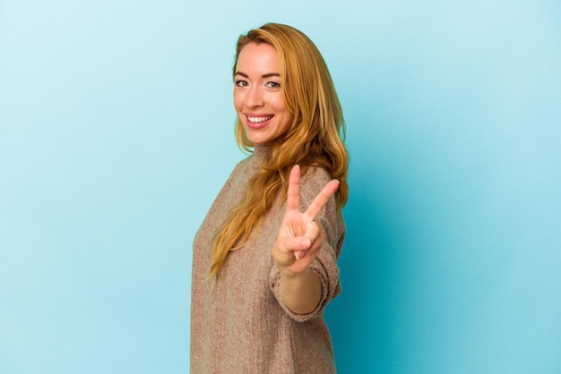 Showing victory sign and smiling broadly