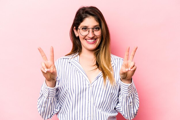 Showing victory sign and smiling broadly