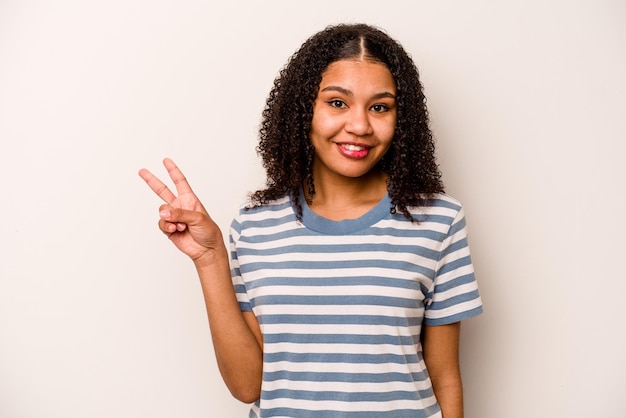 Showing victory sign and smiling broadly