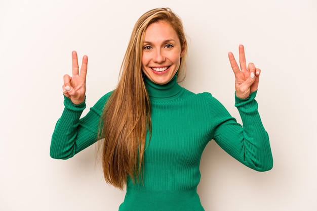 Showing victory sign and smiling broadly