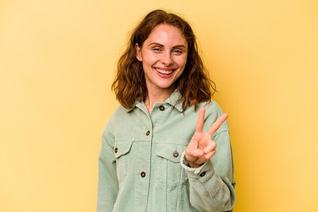 Showing victory sign and smiling broadly