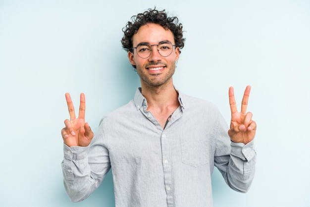 Showing victory sign and smiling broadly