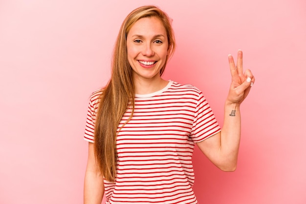 Showing victory sign and smiling broadly