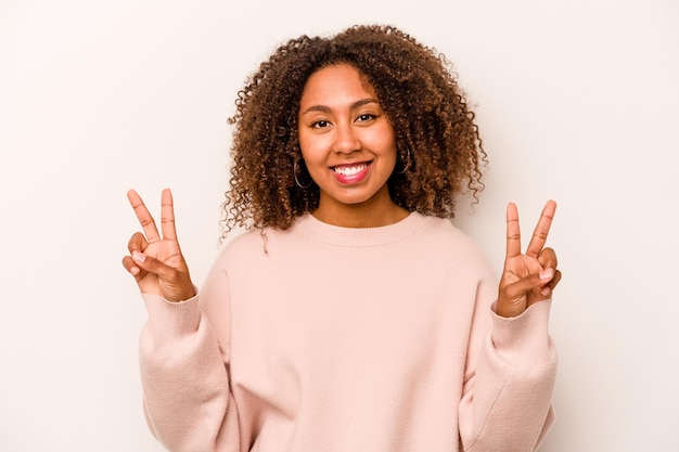 Showing victory sign and smiling broadly