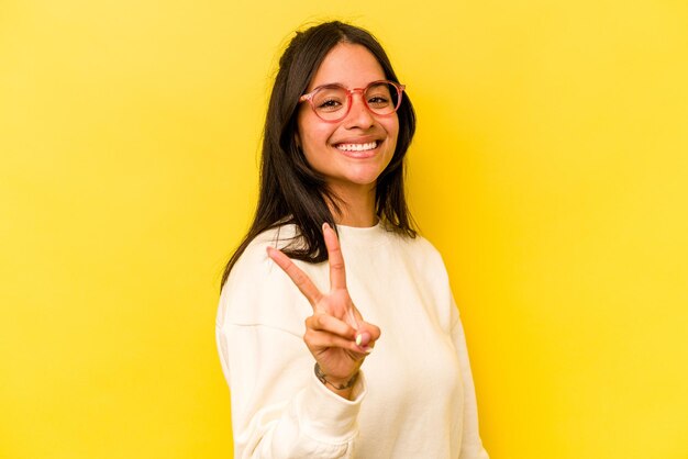 Showing victory sign and smiling broadly