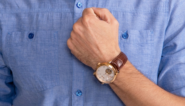 Showing wristwatch. you are late. deadline. time management. mens wardrobe. modern life success. male fashion accessory. checking time with hand watch.