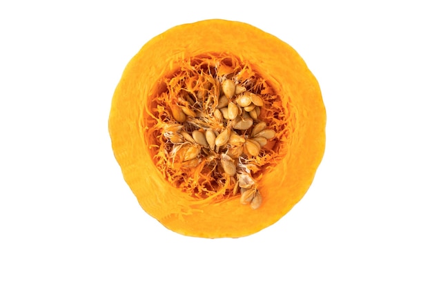 Shown is a cross section of an orange pumpkin with seeds on a white background