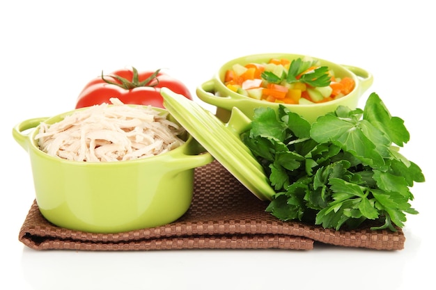 Shredded boiled chicken in green pan close up