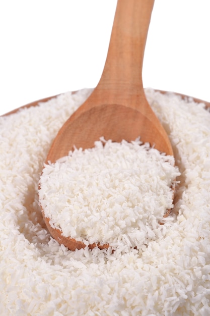 Shredded coconut in a wooden spoon