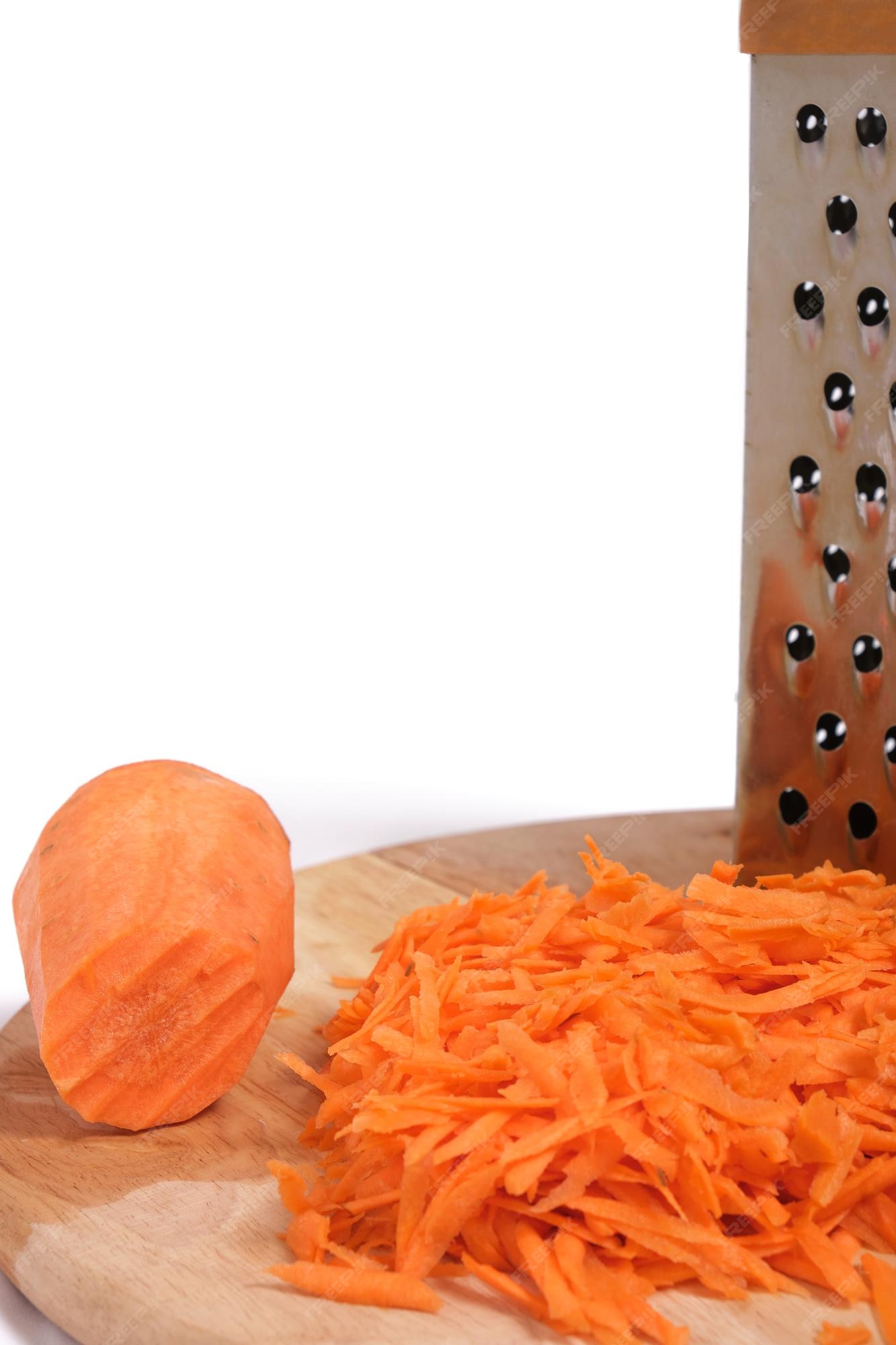 Premium Photo  Shredding grater and shredded carrots on a cutting