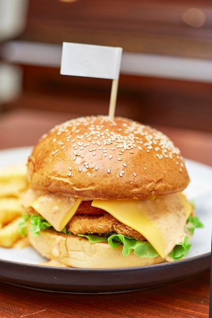 Shrimp burgers with cheddar cheese served on white plate place o