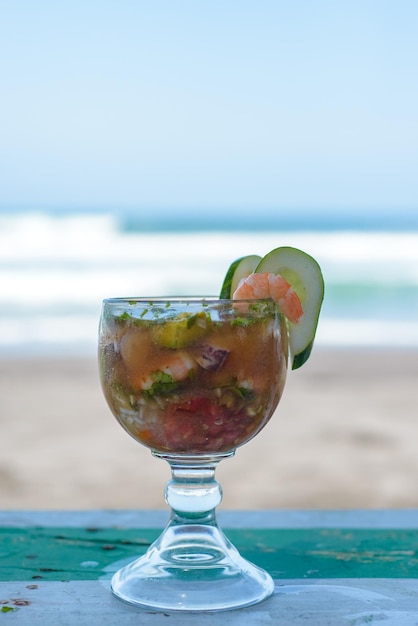 Shrimp cocktail with beach landscape in background Blurred background