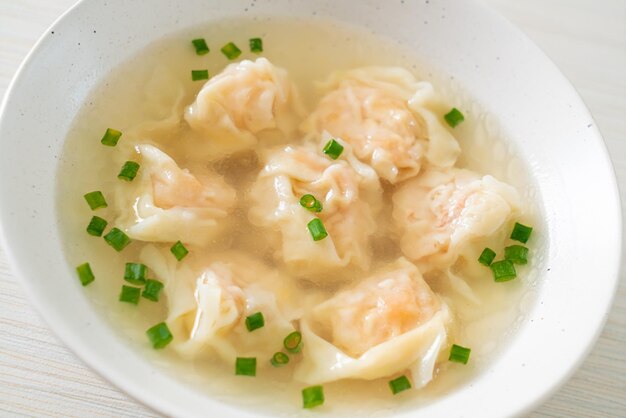 shrimp dumpling soup in white bowl - Asian food style