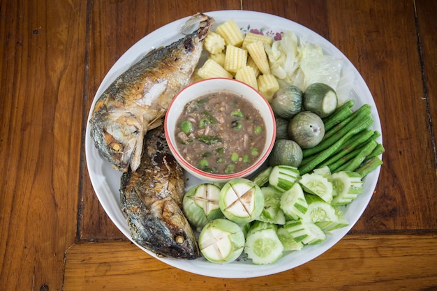 Shrimp paste with fried mackerel and vegetable on wood