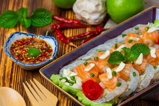 Shrimp and Salmon Spicy Salad on wooden surface