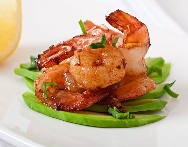 Shrimp sauteed with garlic and soy sauce on a cushion of avocado slices