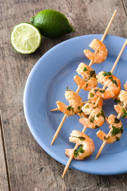 Shrimp skewers on wooden table