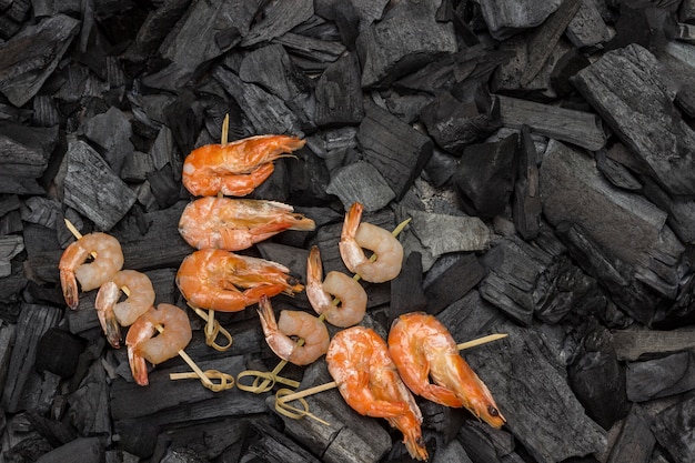 Shrimp and  tiger prawns on charcoal. Copy space.