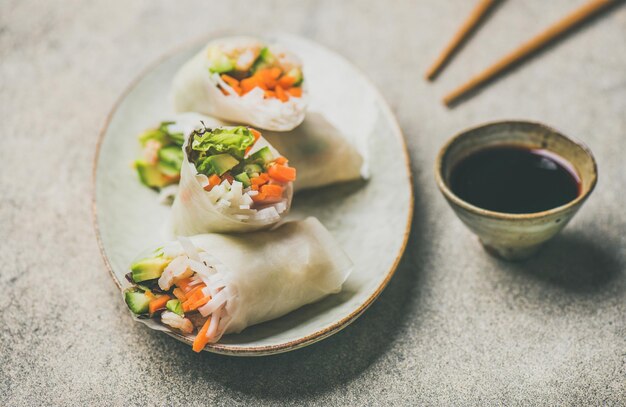 Shrimp and vegetable rice paper spring rolls grey background