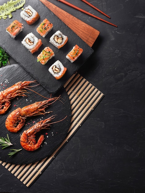 Shrimp with sushi on stone table