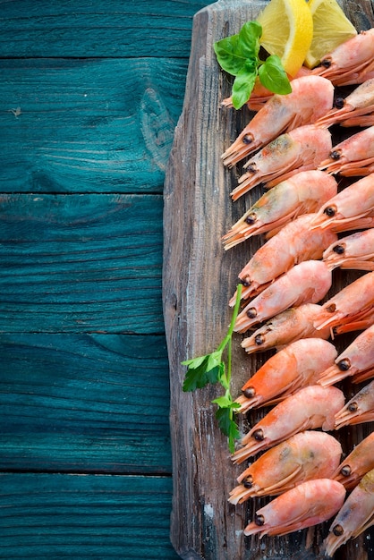Shrimp on a wooden board Seafood On the old background Top view Free copy space