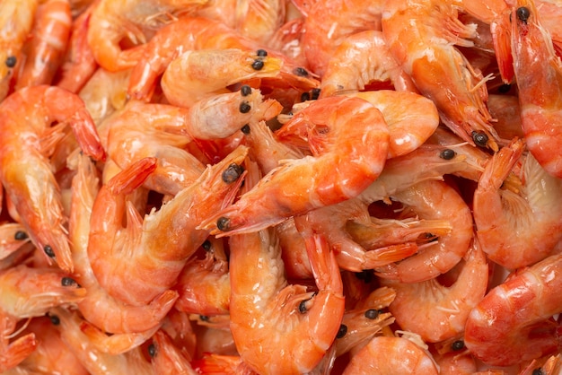 Shrimps background texture. A lot of shrimps. Cooked shrimps.