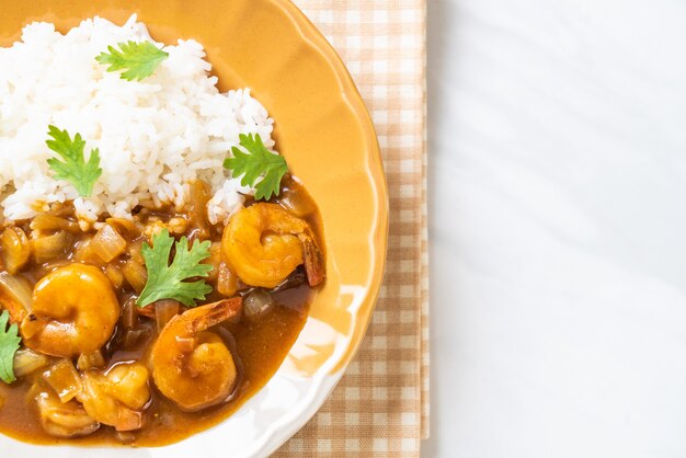 Shrimps in curry sauce on rice