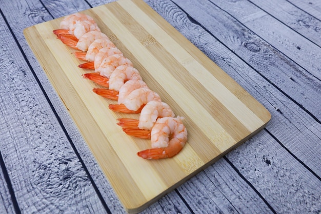 Shrimps peeled and cooked on a wooden table