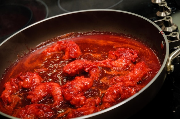 Shrimps with red sauce on the pan