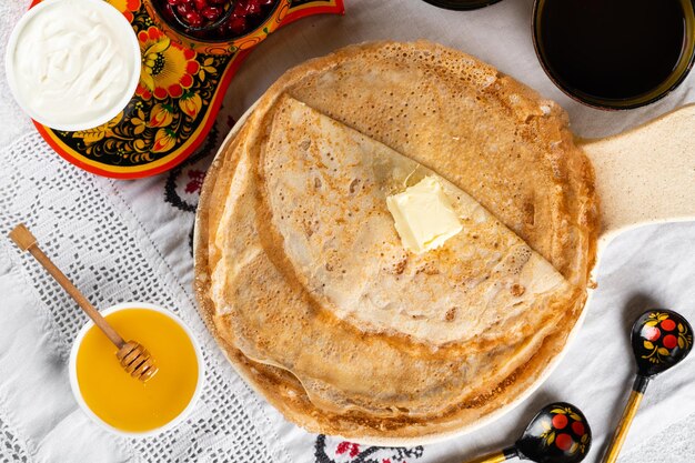 Shrovetide Maslenitsa festival. Russian pancakes blini. Pancakes with honey and jam. Russian spoons. National russian festival. Russian crepes.