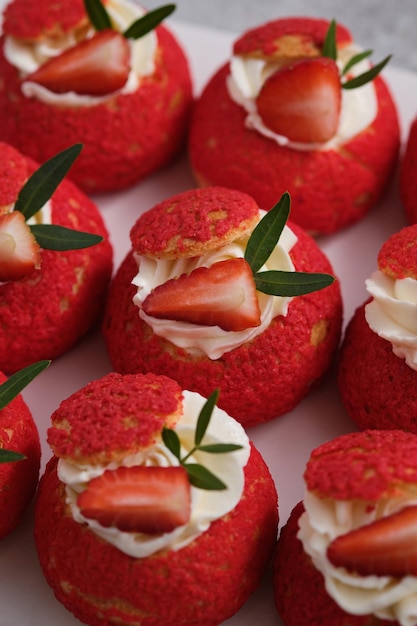 Shu cake. Pastry stuffed with creamy vanilla cream with a crispy top, garnished with strawberries.