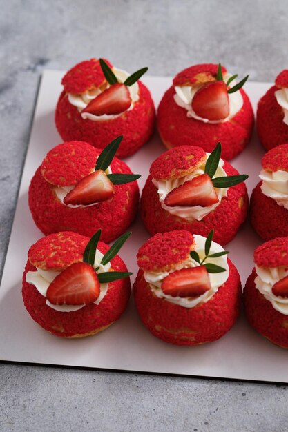 Shu cake. Pastry stuffed with creamy vanilla cream with a crispy top, garnished with strawberries.