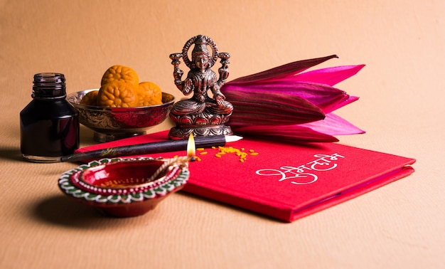 Photo shubha labh written on red accounting note book or bahi khata for laxmi pujan in diwali