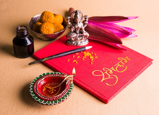 Photo shubha labh written on red accounting note book or bahi khata for laxmi pujan in diwali