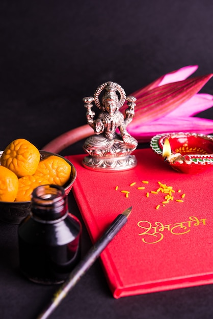 Photo shubha labh written on red accounting note book or bahi khata for laxmi pujan in diwali