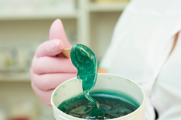 Shugaring paste in a jar on a spatula