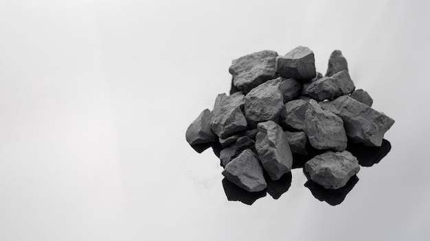 Shungite stones on a white background with a copy space