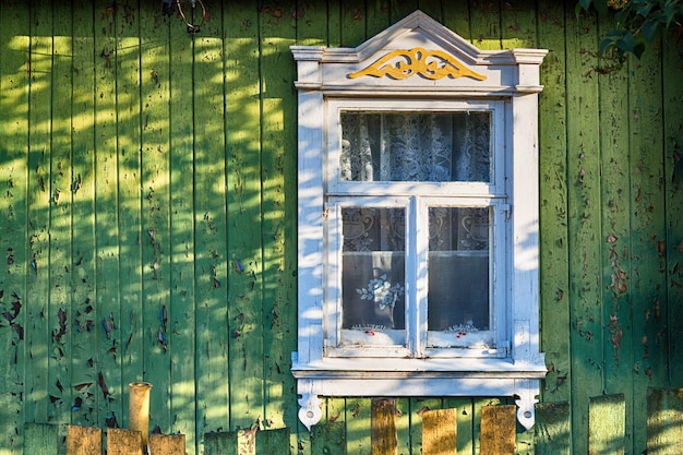 Photo shutters of an old window with a pattern of a rustic old house in a vintage style