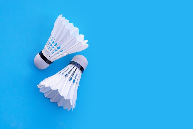 Shuttlecock or badminton balls on blue table.