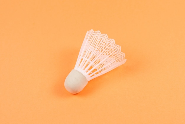 Shuttlecock isolated on orange wall