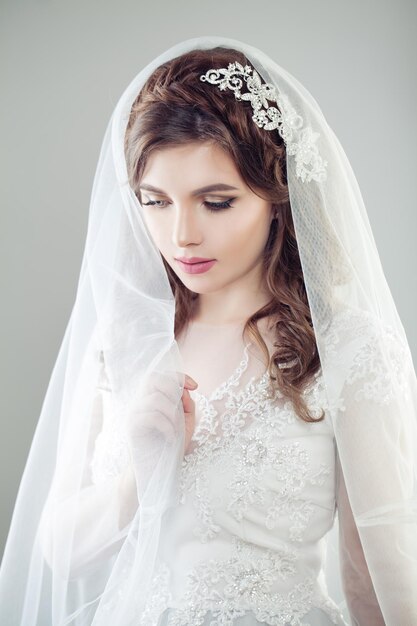 Shy bride woman in white veil