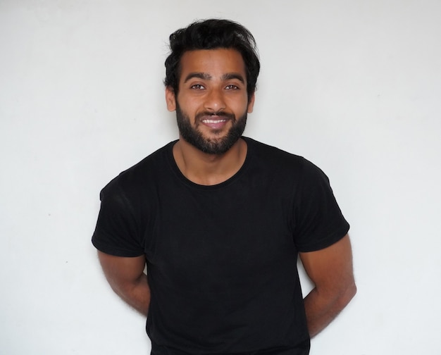 A shy man watching in camera and giving smile portrait