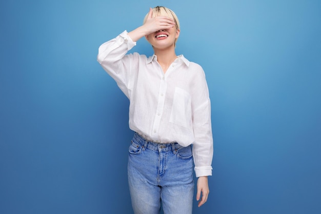 Shy pretty blond office worker woman in white shirt and jeans people lifestyle concept