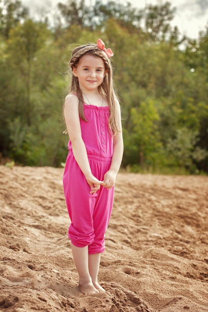 Shy pretty girl posing on beach in park