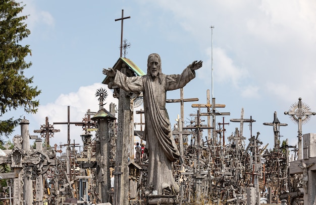 SIAULIAI, LITHUANIA - JUL 28, 2019: Pilgrims on the religious event on the Hill of Crosses. Hill of Crosses is a unique monument of history and religious folk art in Siauliai, Lithuania